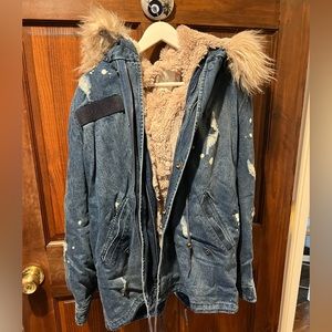 Distressed Denim winter jacket with pink faux fur lining and hood.